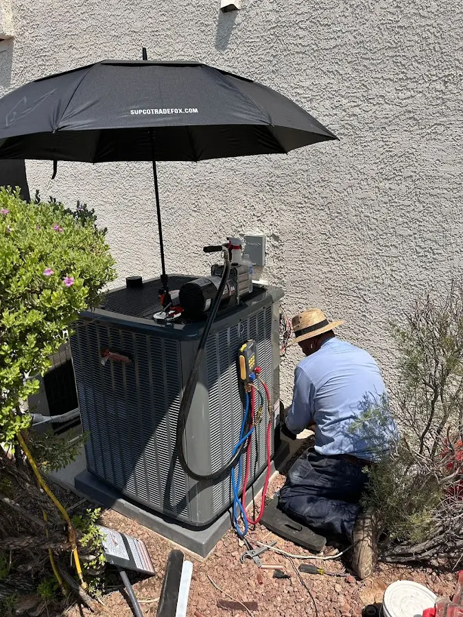 HVAC technician performing outdoor AC maintenance in Maryville